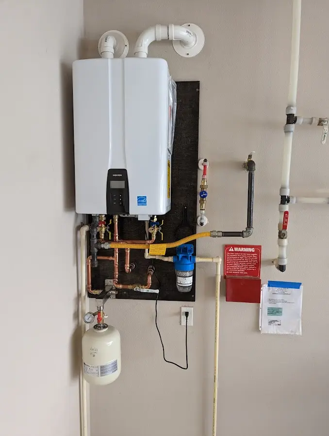 Professional plumber installing copper piping in a Newport News home